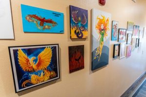 A wall full of student art at a residential program for teens | Discovery Ranch South, a Residential Treatment Center for Girls and Teens Assigned Female At Birth