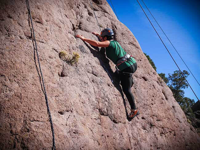 A teen participates in Rock Climbing therapy while attending Discovery Ranch South, a residential treatment center for teens in crisis