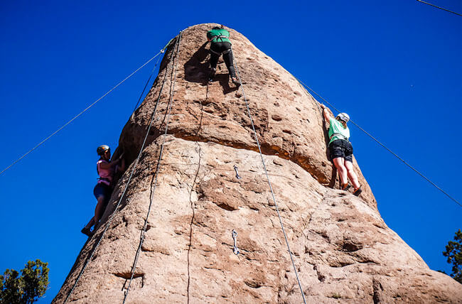 Girls participate in a Rock Climbing Teamwork Challenge while attending Discovery Ranch South, a teen treatment center