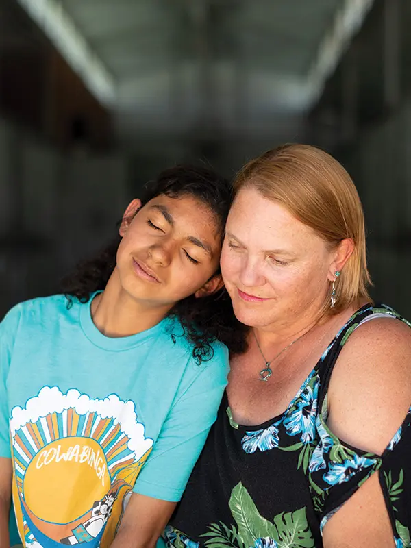 A mother hugs her daughter during a family therapy visit at Discovery Ranch South, a residential treatment center for girls and teens assigned female at birth.