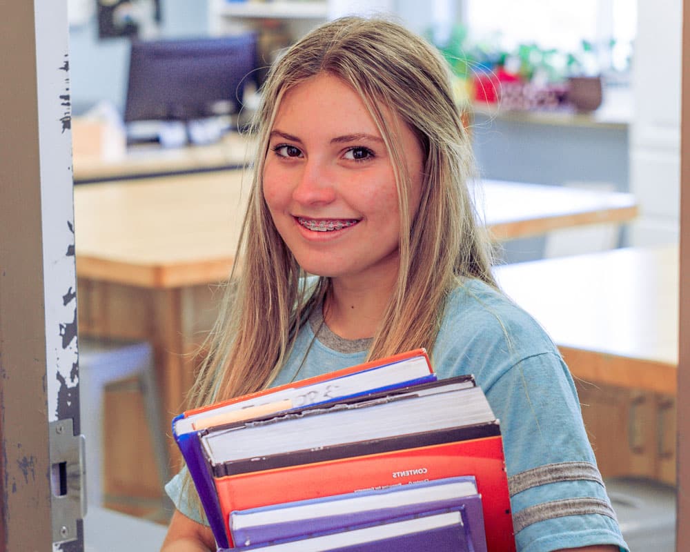 A girl attends a therapeutic school while attending Discovery Ranch South's residential treatment for girls and teens assigned female at birth