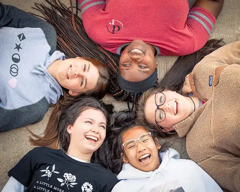 Students laughing and having fun while attending a Teen Residential Treatment Center for Girls & Youth Assigned Female at Birth | Discovery Ranch South