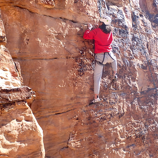 A teenage girl developes grit while rock climbing as part of her adventure therapy program at Discovery Ranch South, a teen treatment center for girls and adolescents assigned female at birth