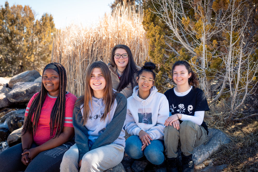 Students smile and pose for a photo while attending residential program for teens at Discovery Ranch South, a residential Treatment Center for Girls and Teens Assigned Female at Birth
