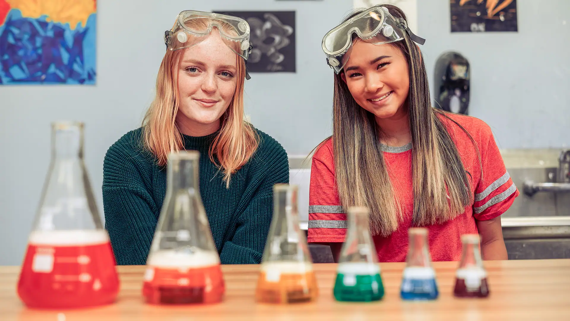 Teens smile at the camera while participating in a science class at Discovery Ranch South, a Residential Treatment Center for Teenage Girls and Youth assigned Female at Birth